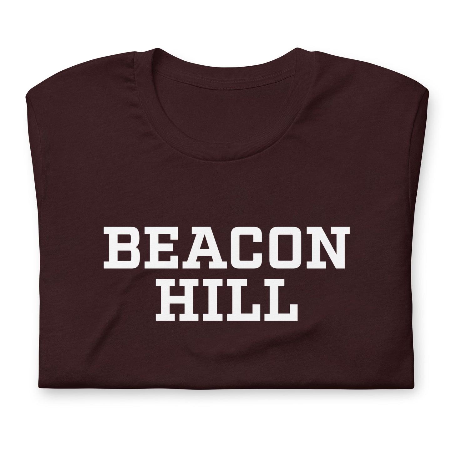 Graphic t shirt displaying "Beacon Hill", a neighborhood in Boston, MA. The shirt shown is dark red, folded..